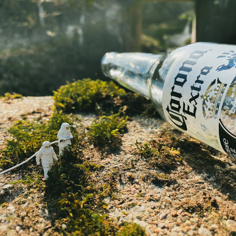 Zwei Miniaturfiguren vor einer Flasche